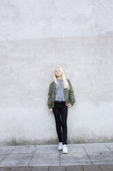 Portrait of girl standing against concrete wall - FOLF05532