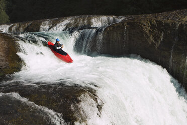 Kayaker paddling through waterfall - CAVF31249