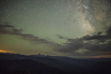 Scenic view of silhouette mountains against star field at night - CAVF31295