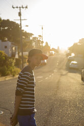 Boy standing on suburban road in Pacific Grove - FOLF05794