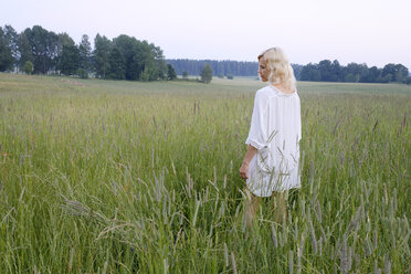 Woman walking in meadow - FOLF06010