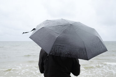 Woman under black umbrella watching Baltic Sea - FOLF06014