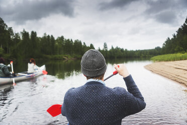 Man rowing on river in north of Sweden - FOLF06407