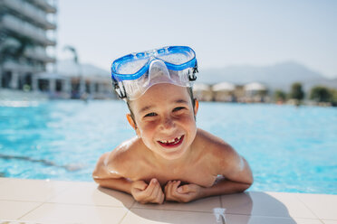 A happy young boy leaning on the edge of a pool - FOLF06561