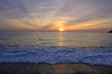 Italy, Liguria, Riviera di Ponente, Gulf of Genoa, Noli, sunrise at beach - LBF01882