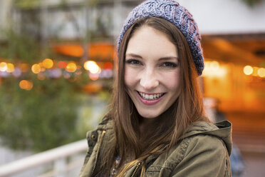 Close-up portrait of happy woman at airport - CAVF32117