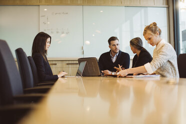 Business people discussing in meeting at board room - CAVF32207