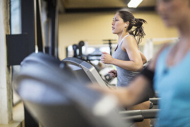 Women exercising on treadmills in health club - CAVF33087