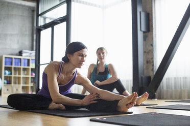 Women exercising on exercise mats in gym - CAVF33154