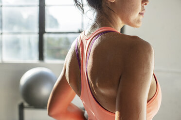 Midsection of female athlete standing in gym - CAVF33284