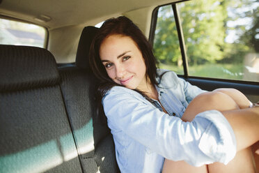 Portrait of smiling woman traveling in car - CAVF33473