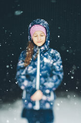 Portrait of girl wearing jacket in snowfall - FOLF06705