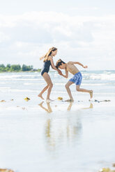 Mädchen und Junge tanzen am Strand - FOLF06714