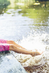 Low section of girl splashing water with legs - FOLF06720