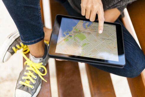 Close-up of woman using tablet with digital street map - VABF01524