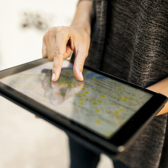 Close-up of woman using tablet with digital street map - VABF01527