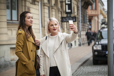 Zwei junge Frauen nehmen Selfie-Foto auf der Straße - FOLF06863