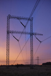 Electricity pylons against dramatic sky at sunset - FOLF07164