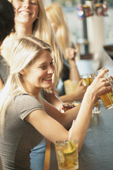 Blonde women drinking beer in bar - FOLF07276