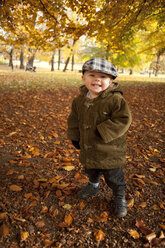 Portrait of boy standing in park in autumn - FOLF07631