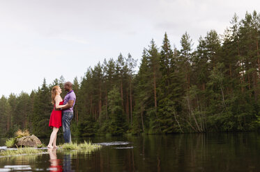 Mid adult couple embracing in river - FOLF07685