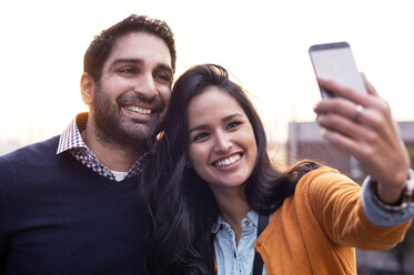 Couple taking selfies at sunset - CAVF33512