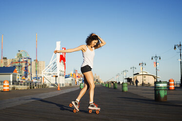 Woman rollerskating on promenade - CAVF33513