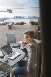 Businessman at outdoor cafe - FOLF08157