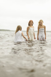 Three girls standing in water - FOLF08460