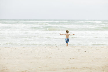 Boy standing on beach in Denmark - FOLF08544