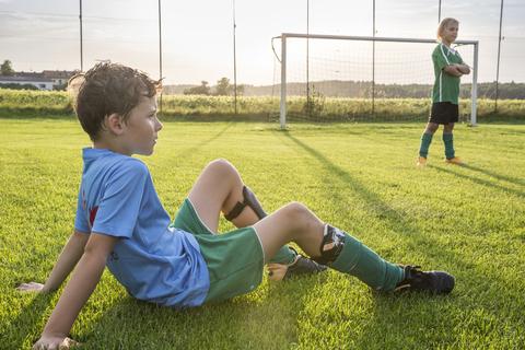 Two young football players on football ground stock photo