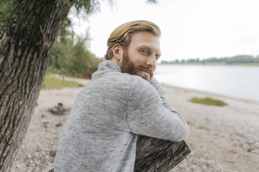 Germany, Duesseldorf, portrait of content man relaxing on the beach - KNSF03674