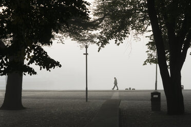 Silhouette eines Mannes auf dem Bürgersteig in Stockholm - FOLF08970