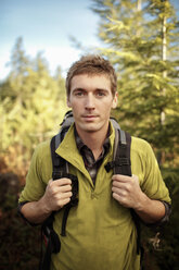 Portrait of confident male hiker standing in forest - CAVF33966