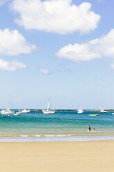 Scenic view of beach with sailboats against cloudy sky - CAVF34127