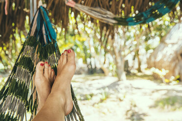 Low section of woman relaxing on hammock during summer - CAVF34222