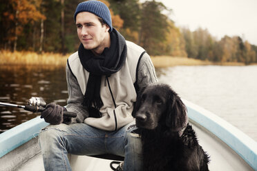Young fisherman and dog in boat - FOLF09137