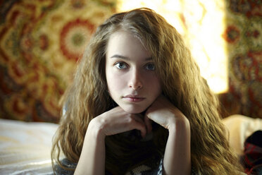 Portrait of confident woman lying on bed - CAVF34308