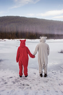 Couple wearing costumes and holding hands - CAVF34380