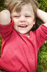 Close up of girl lying in grass - FOLF09237