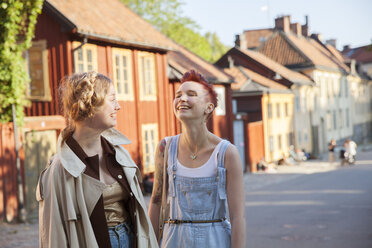Two smiling female friends standing on street - FOLF09358