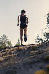 Mid adult woman running of road - FOLF09458