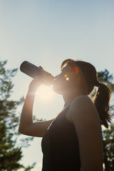 Woman drinking while having break from running - FOLF09461