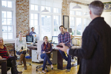 Business people looking at businessman explaining in meeting - CAVF34452