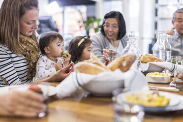 Family eating food in restaurant - CAVF34716