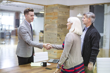 Business people shaking hands in meeting at office - CAVF34825