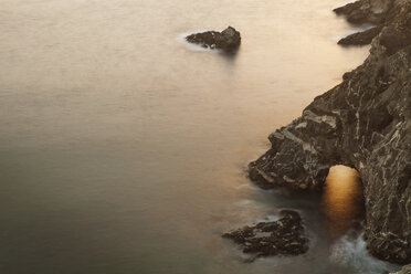 Natural arch by sea at sunset - CAVF34837