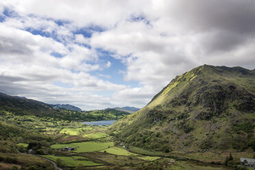 Scenic view of green landscape against cloudy sky - CAVF35035