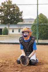 Baseball catcher kneeling on field - CAVF35127