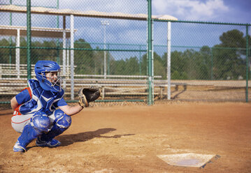 Baseball catcher crouching on field - CAVF35130